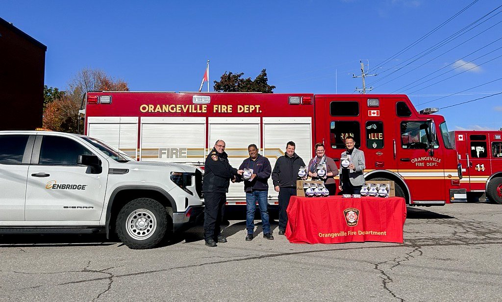 Orangeville Fire and dignitaries in front of a fire truck making an announcement